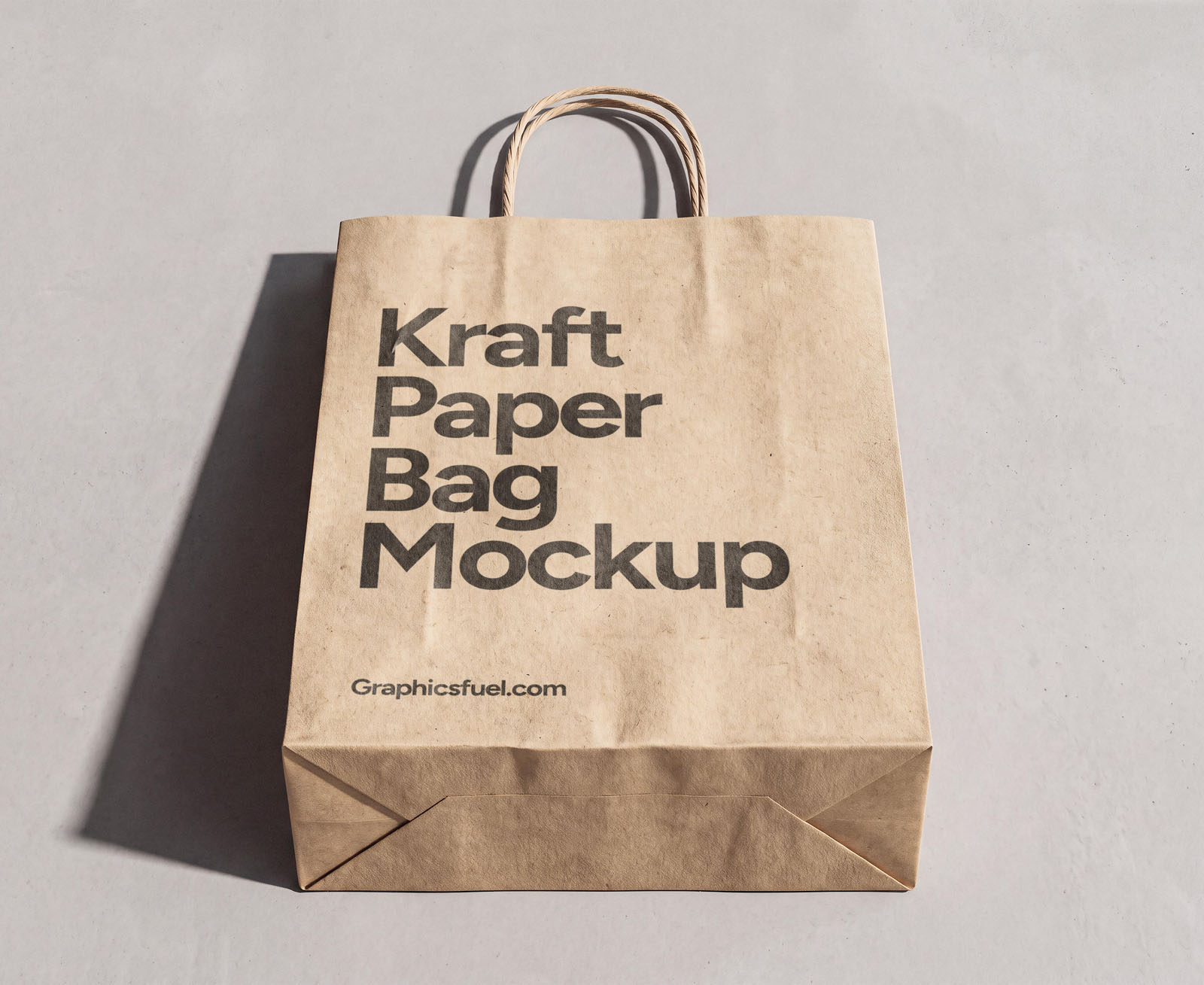 Front view kraft paper bag mockup standing on a concrete floor