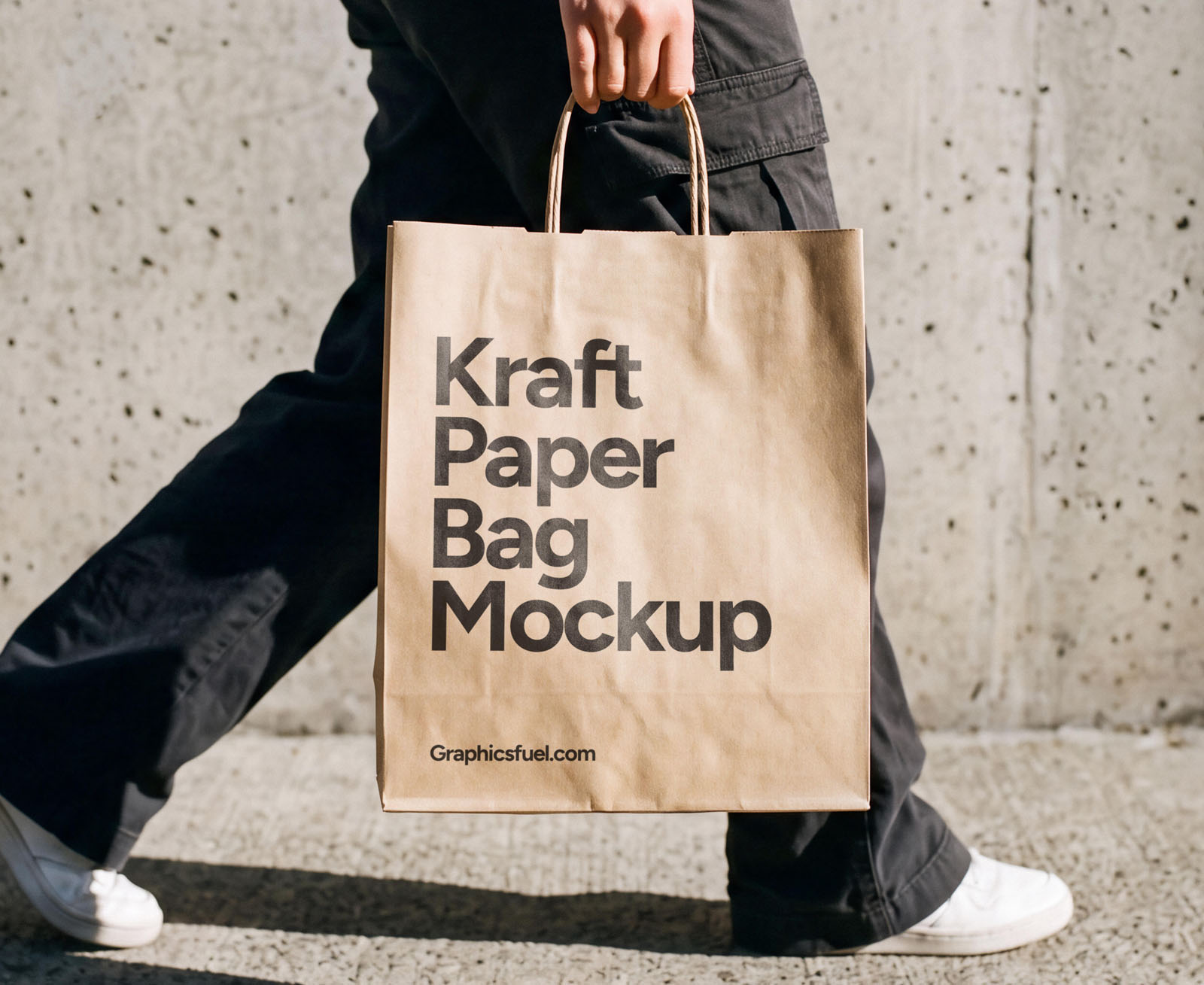 Kraft paper shopping bag mockup carried by a woman mid-stride