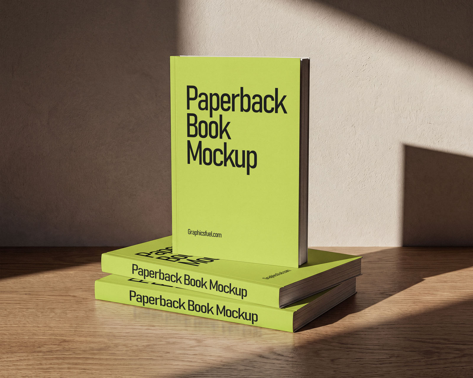 Paperback book mockup PSD showing a stack of three books with one standing upright