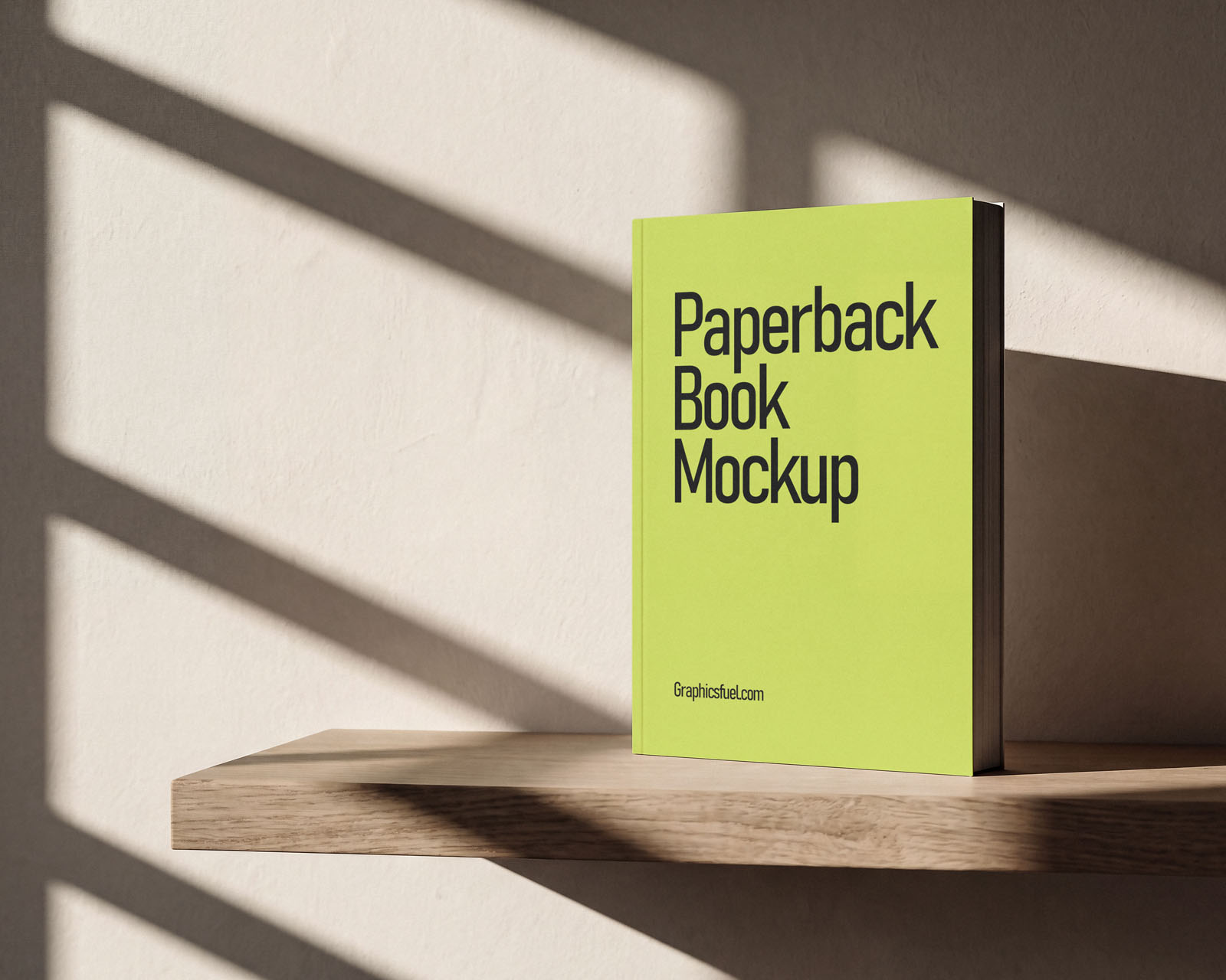 Paperback book mockup on a floating shelf in window light