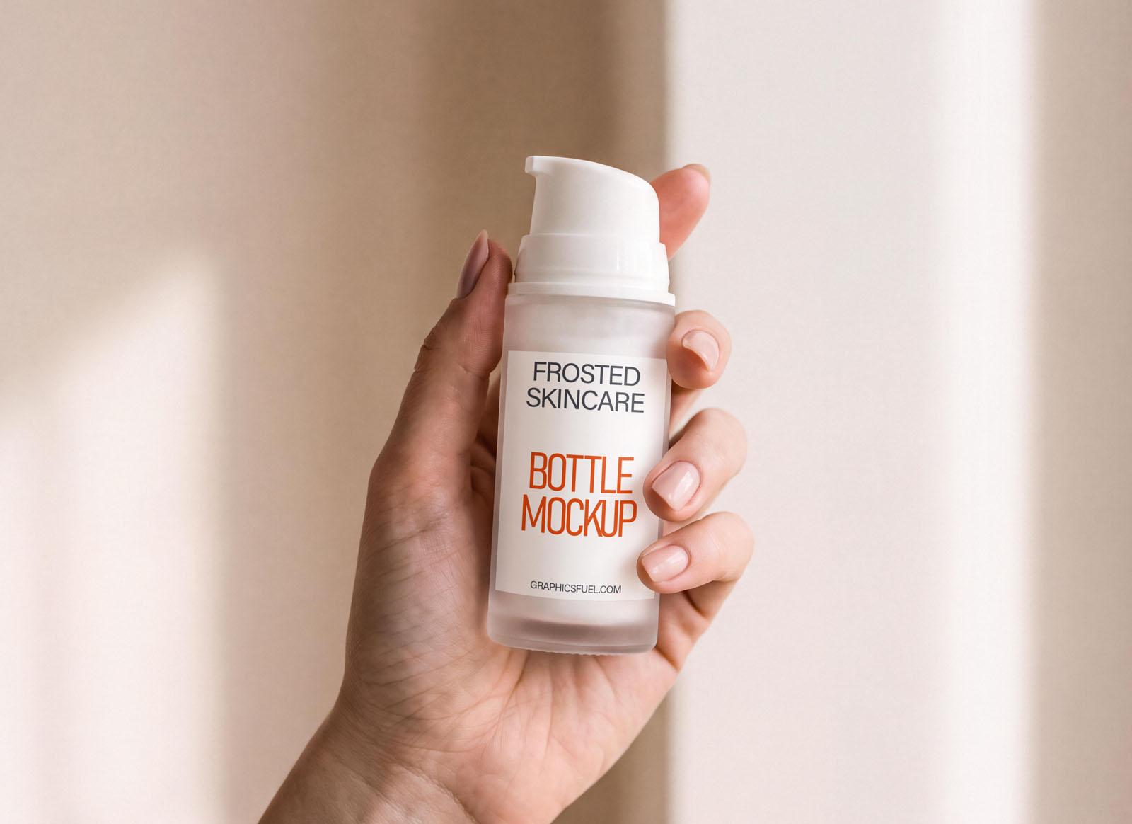 Frosted glass pump bottle mockup held in hand in soft daylight