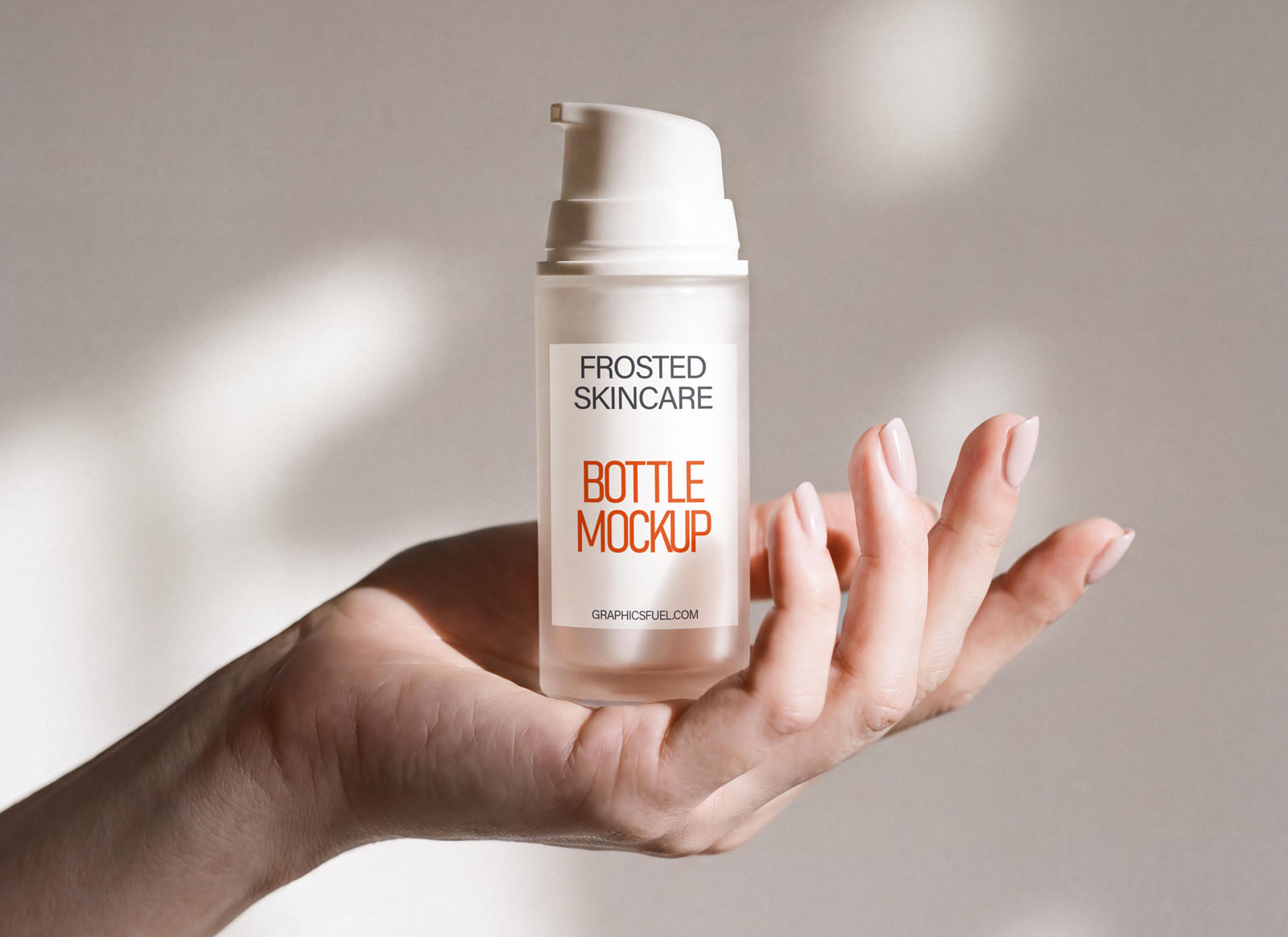 Frosted glass pump bottle mockup held in hand in soft daylight