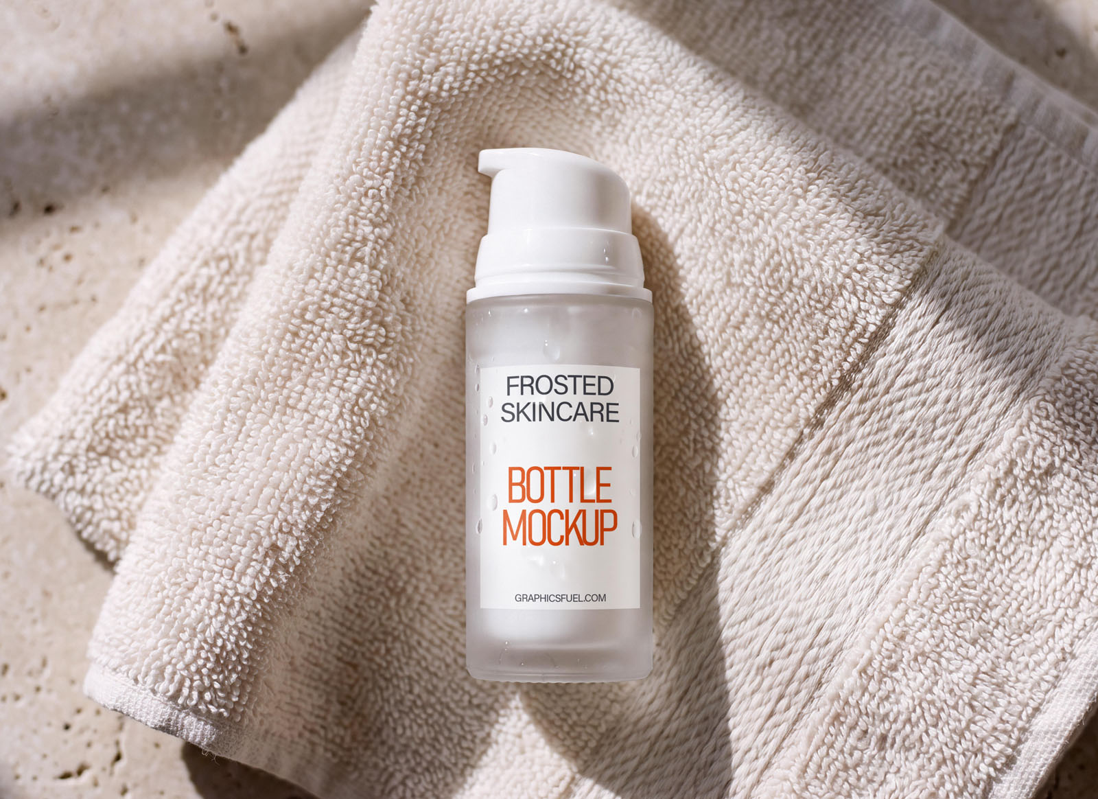 Frosted cosmetic bottle mockup resting on a draped beige towel