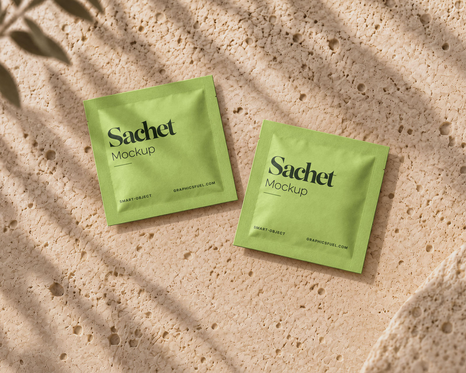 Two individual sachet packaging mockups arranged on a textured stone background.